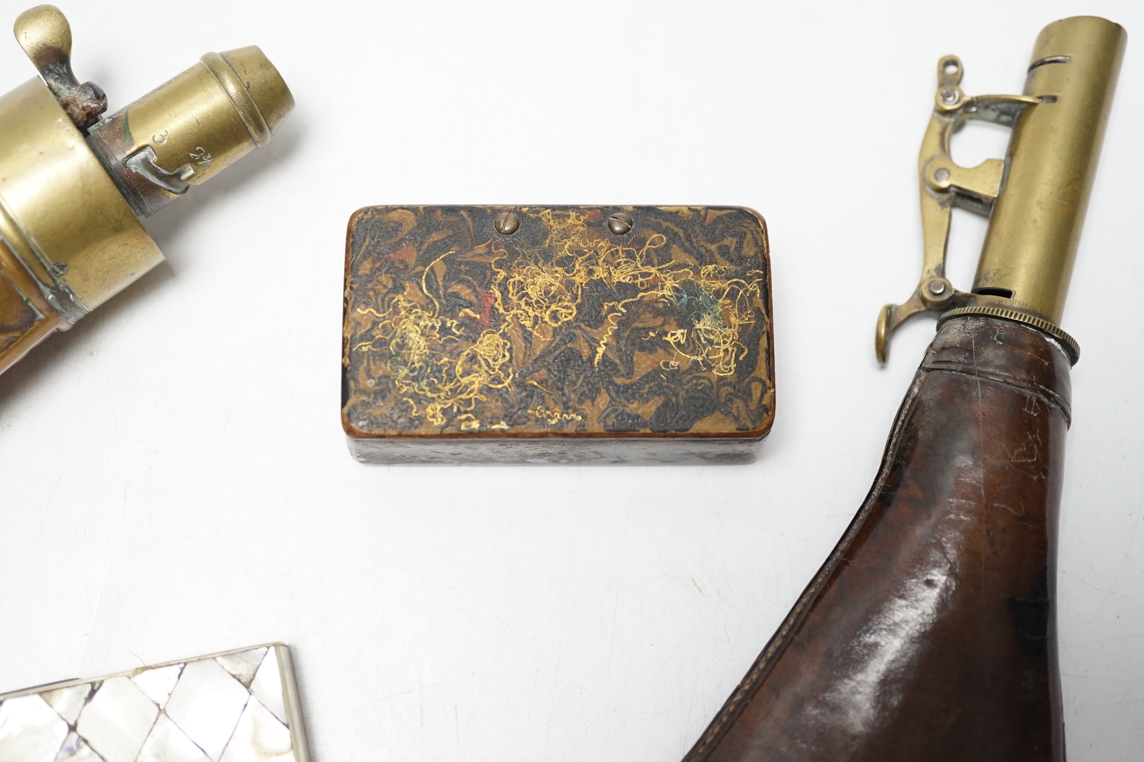 A Victorian embossed brass powder flask, a leather shot flask and a Victorian mother of pearl and abalone calling card case